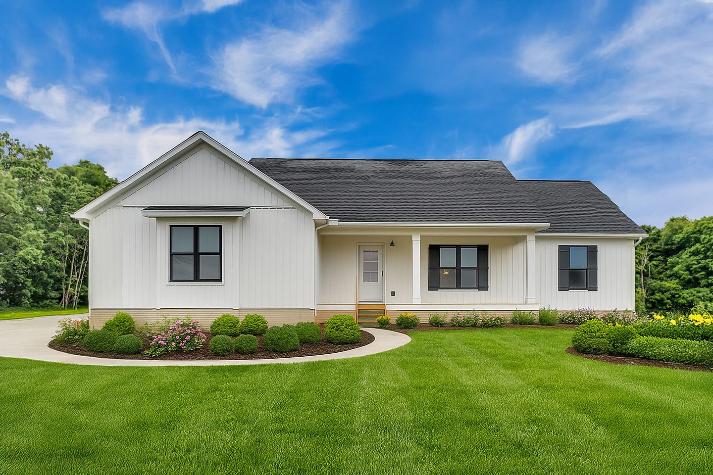 Front elevation of a custom ranch home with white siding, black shutters, and a covered front porch.