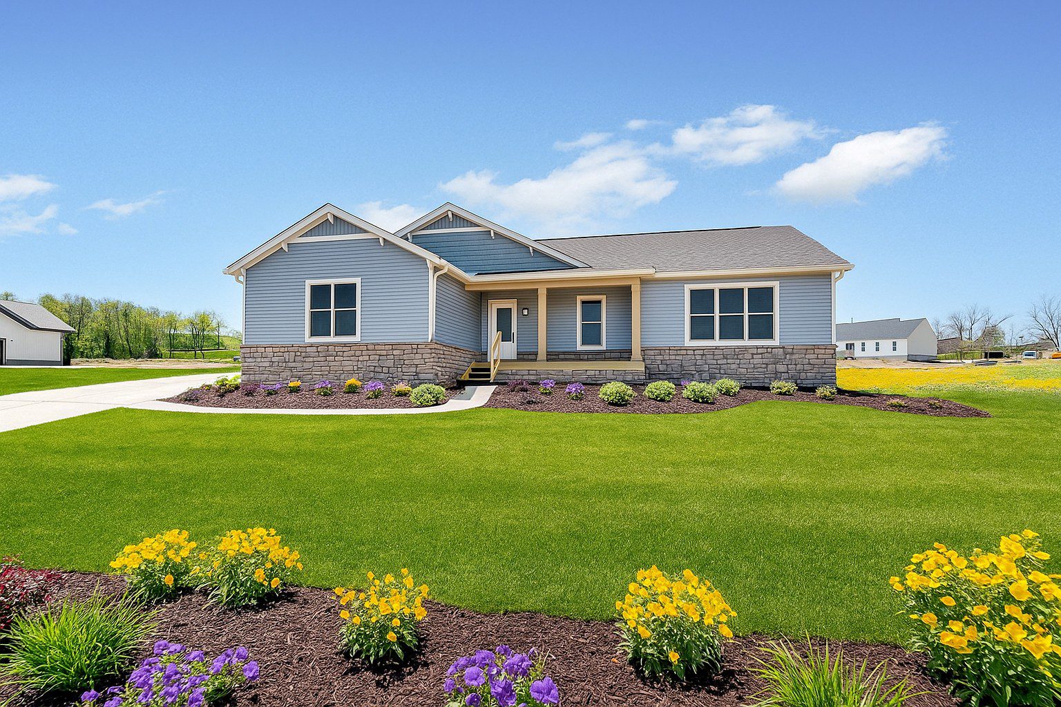 Single-story ranch style custom home with large front lawn and colorful landscaping in Ohio.