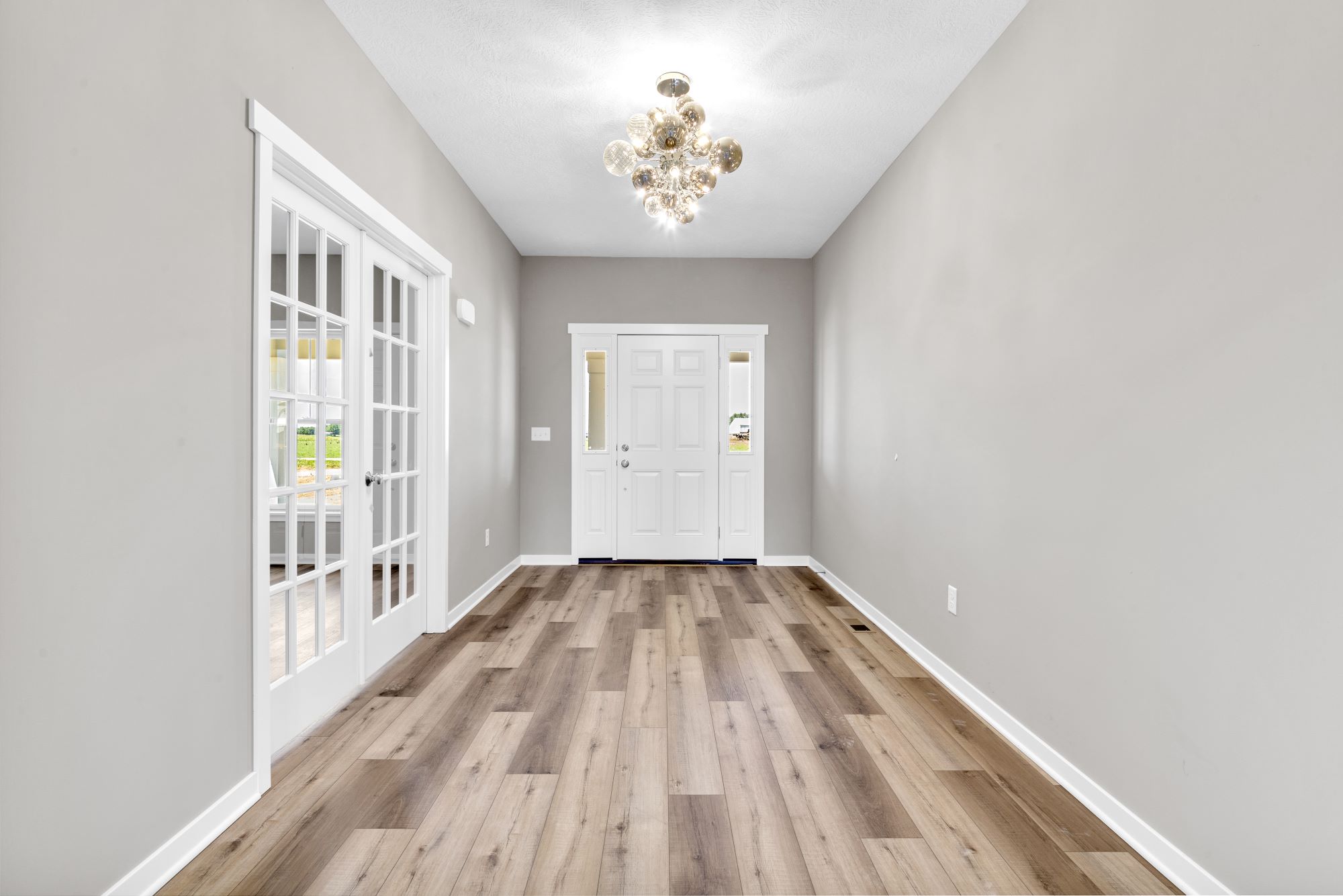 Entry of a modified two story custom home called the Crestline with beautiful bauble lighting.