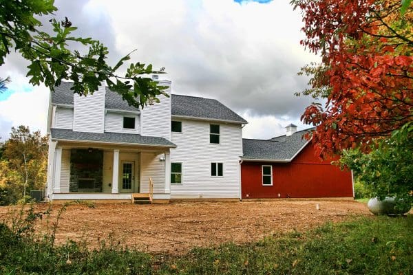 Rear exterior of the Madison II with a great covered patio that stretches along the rear of the home.