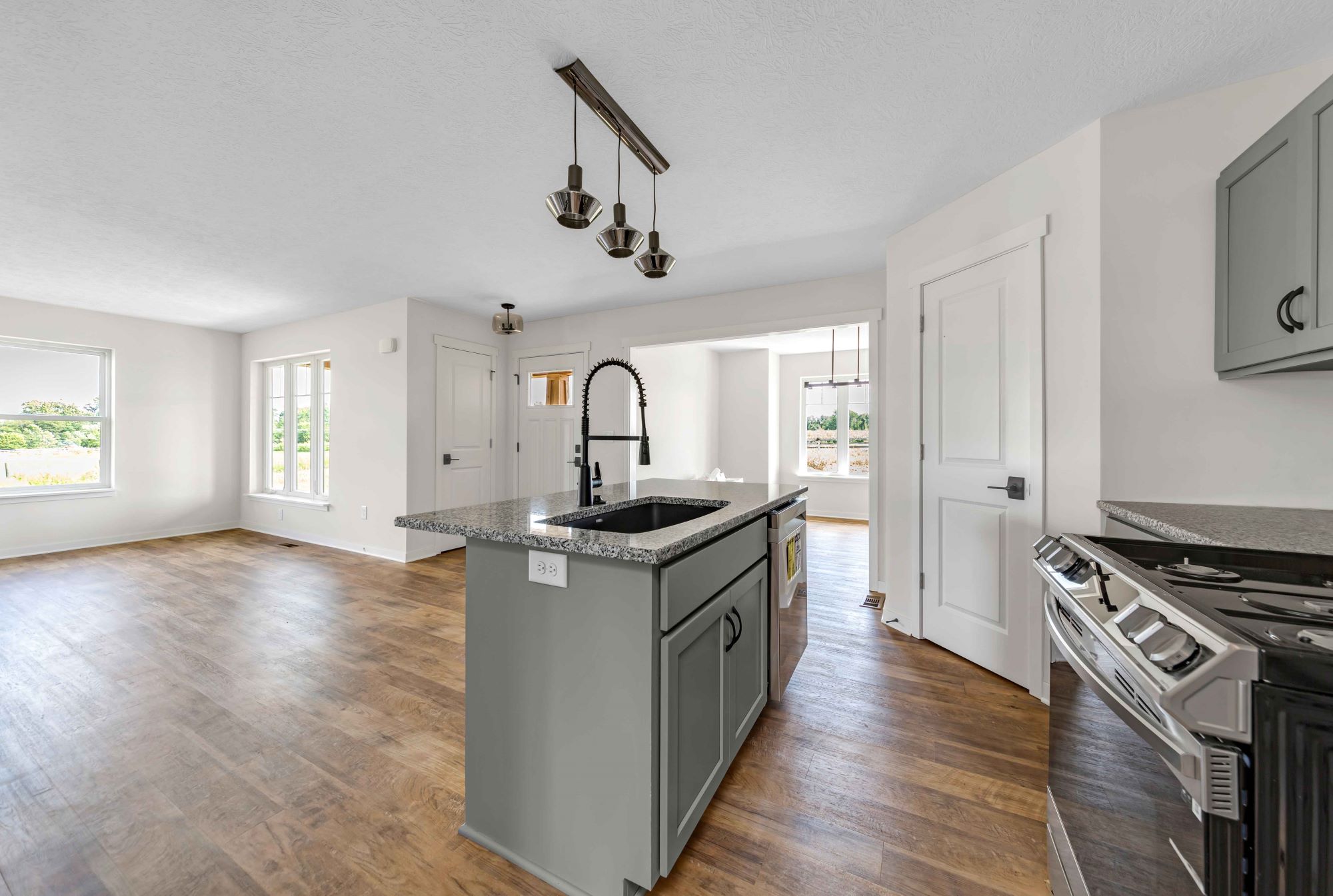 The Barrington kitchen with summit gray countertops and view towards the dining room.