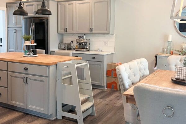 Bright open-concept kitchen overlooking the great room with a large center island, pendant lighting, and abundant natural light.