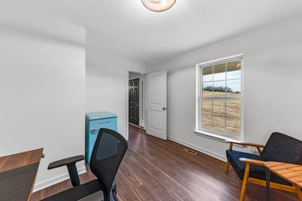 Office in the Adams with white walls, lvp flooring, accessible from the front door.
