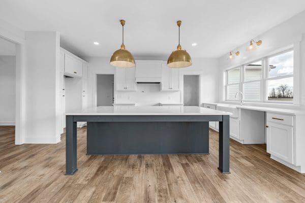 Jefferson floor plan kitchen with gold light fixtures and large island in iron ore color.