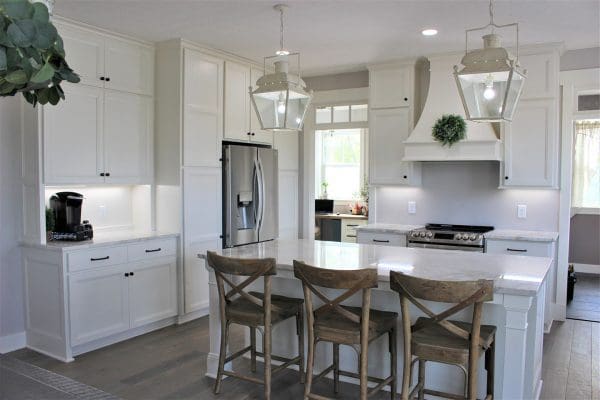 Custom kitchen with custom wood hood and transom windows.