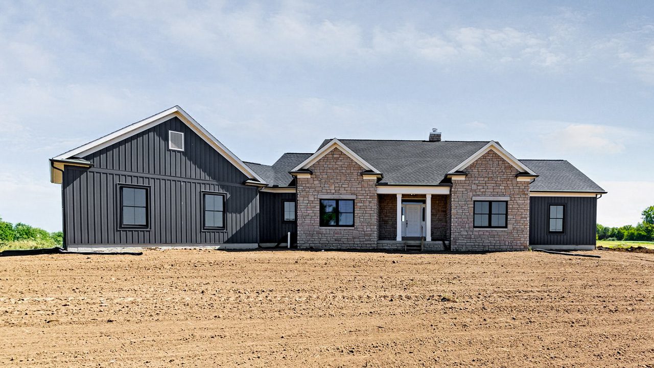 Video walk through photograph of the Charlotte with stone and nightfall siding.