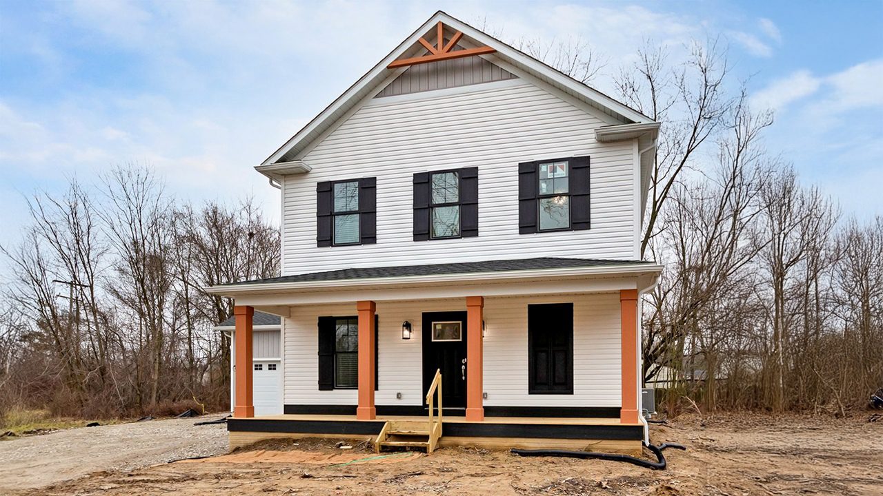 Image of the heights with black shutters and windows and white siding.