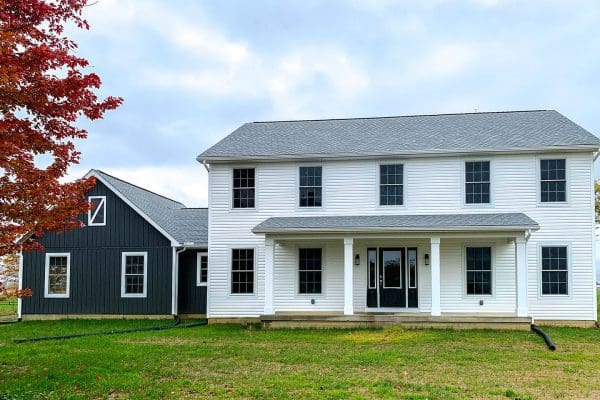 The Madison II floor plan with blue siding on garage and white siding on home.