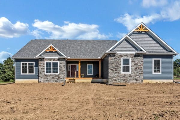 Exterior of the clark with blue siding and stone on bedrooms 2 and 3.