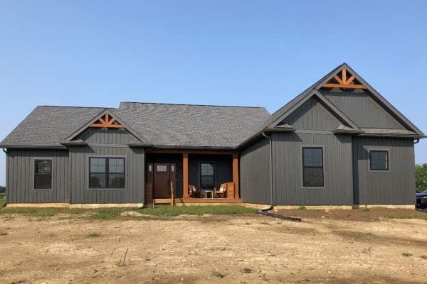 Clark floor plan with dark gray night fall siding and stained gable brackets.