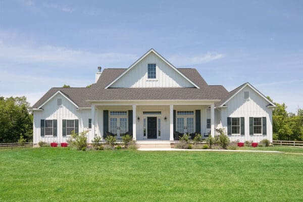 The Pinehurst with white board and batten and green front door and shutters.