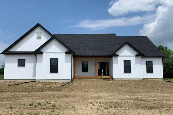 The Clark with white siding, black roof and stained porch columns.