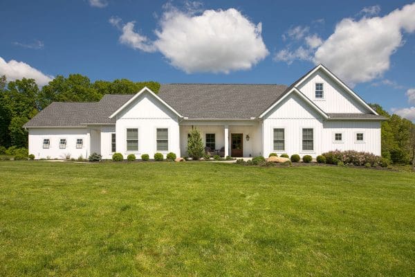 Jonas custom farmhouse design featuring white siding.