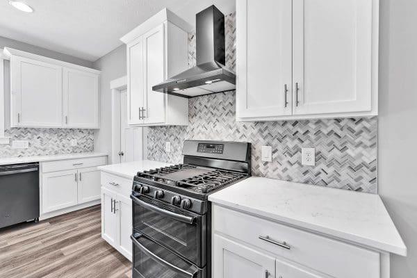 Custom kitchen with v-shaped tile back splash.