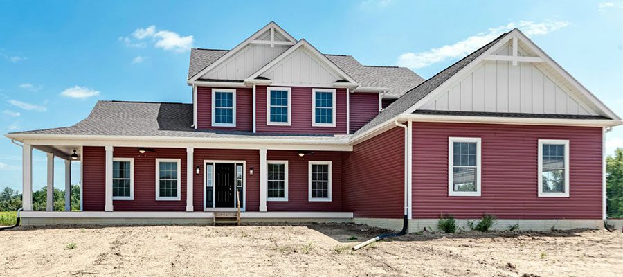 The Oxford with red siding and white board and batten in the gables blog main photo image.