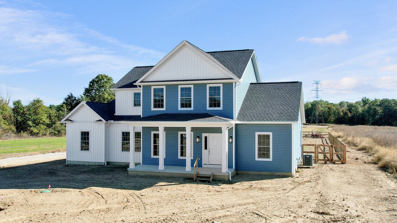 The Danbury two store modern traditional farmhouse with blue and white siding.