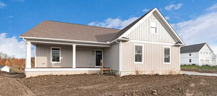 Blog main photo image of the Anthony with tan board and batten siding and white board and batten in the garage eaves.