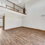 Two story family room of customized Walnut Creek design with wood flooring and sliding door.