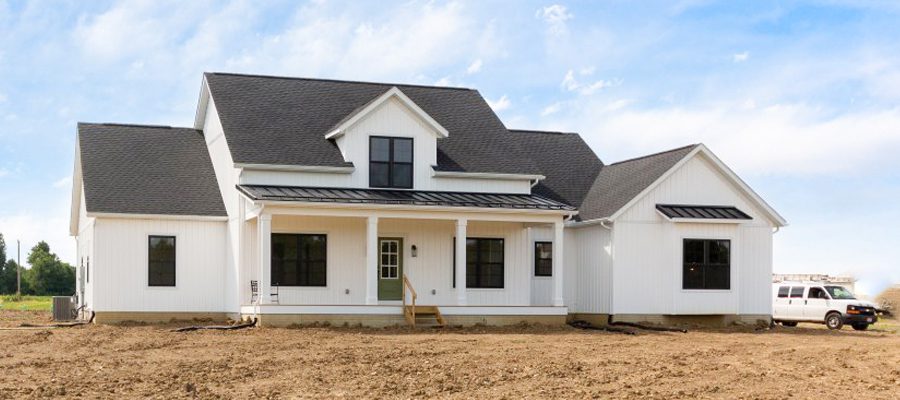 Charles Pointe with gable dormer gray shingles, black windows and green front door blog header image.