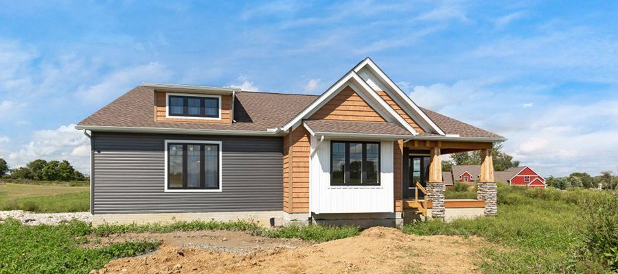 Blog header of the Barrington exterior with white board and batten, blue horizontal siding and cedar shake exterior.