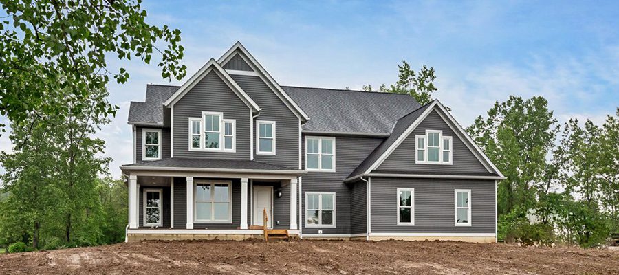 Image of the exterior of the grant with dark siding and white trim.