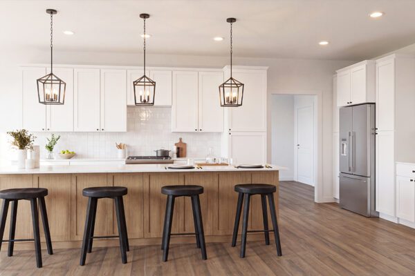 White kitchen with large island, pendant lights and hardwood floors