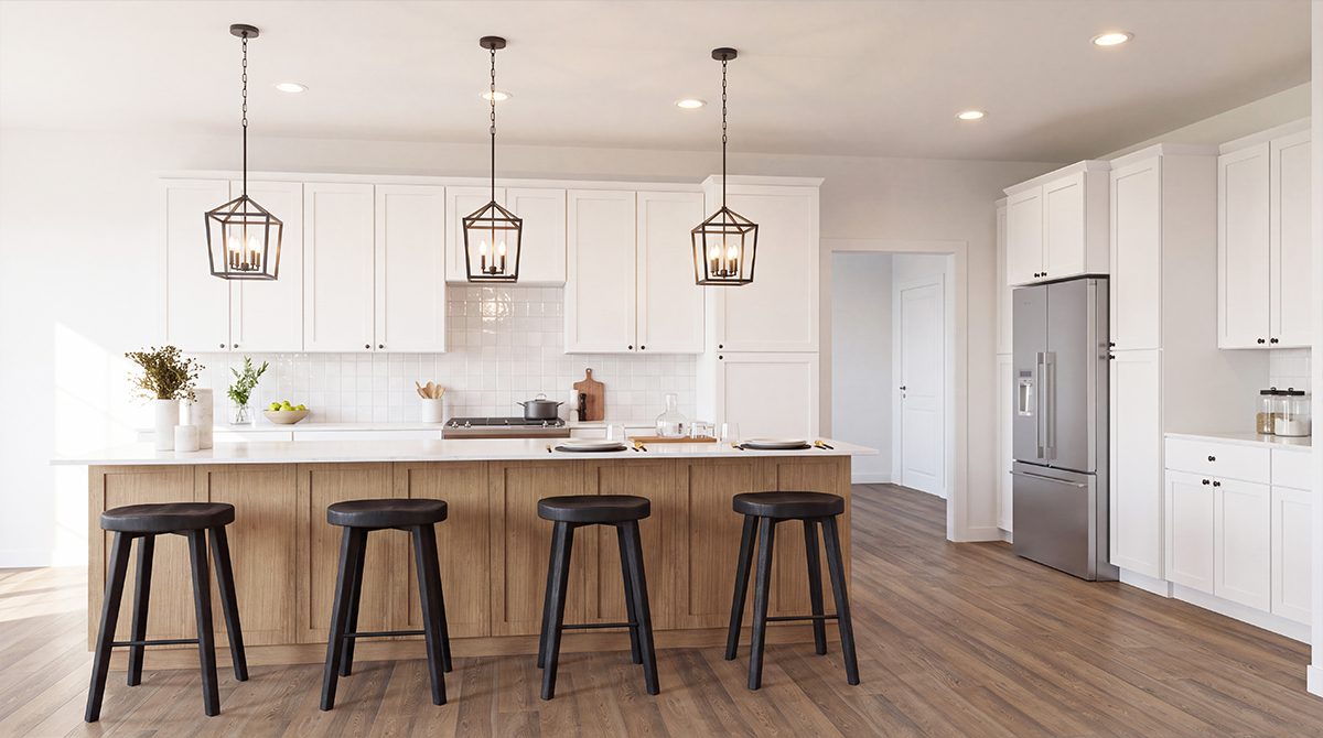 White kitchen with large island, pendant lights and hardwood floors
