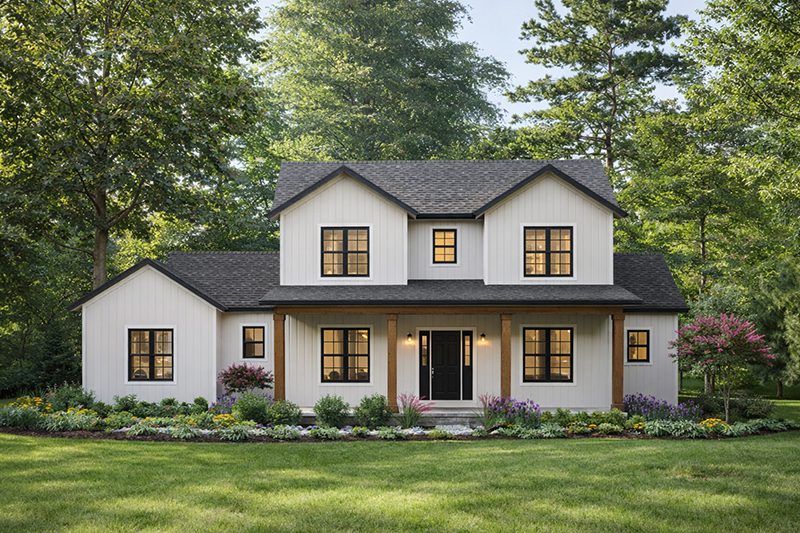 White two-story farmhouse with Andersen windows, black front door, covered porch, and lush landscaping.