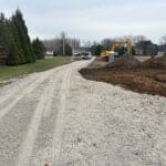 Gravel construction driveway leading to future home site