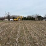 Construction equipment preparing a custom home site before excavation begins
