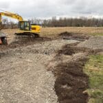 Excavation equipment digging foundation area for Madison II home