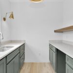 Custom prep kitchen with built-in cabinetry and countertop workspace