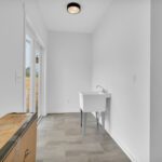 Custom pet area with built-in washing station and Graphite tile flooring
