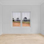 Home office with white oak floors, large windows and warm white walls