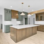 Custom kitchen cabinetry mixing Sherwin-Williams Rosemary green with Smokey Brown stained maple